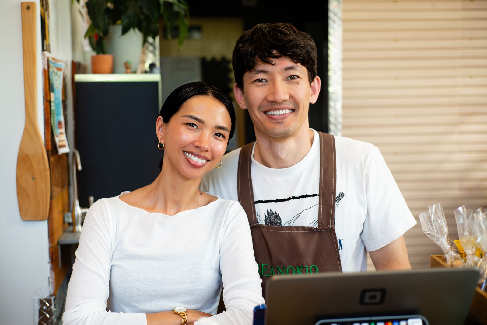 Two small business owners standing together